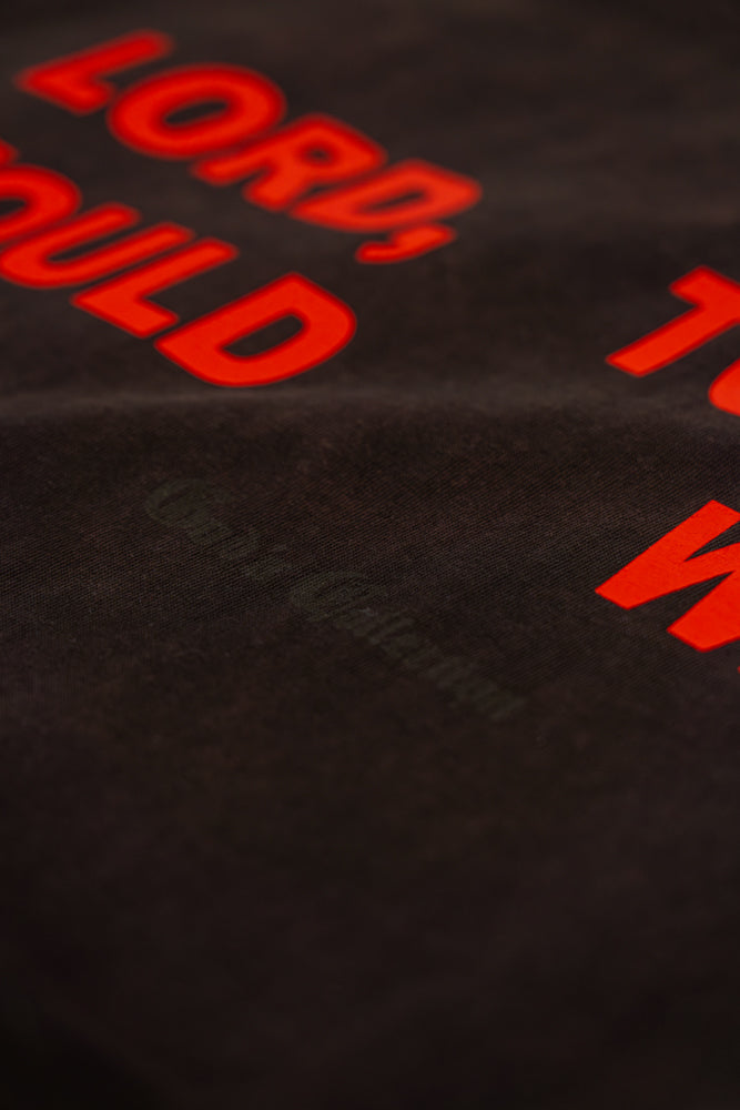 Black fabric with red text 'LORD, TO WHO WOULD WE GO' partially visible